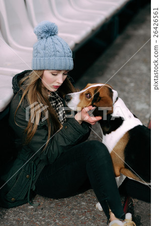 Young hipster girl with her pet estonian hound dog Young hipster girl with her pet estonian hound dog 26426561