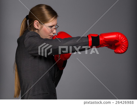 Strong and resolute young woman in dark grey business suit, glas Strong and resolute young woman in dark grey business suit, glas 26426988