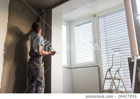Plasterer renovating indoor walls and ceilings 26427938