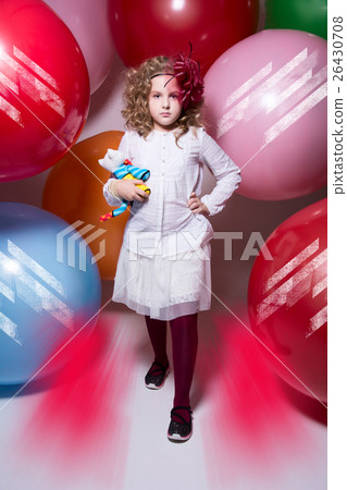 Beautiful girl in a white blouse with a soft toy comes at camera Beautiful girl in a white blouse with a soft toy comes at camera 26430708