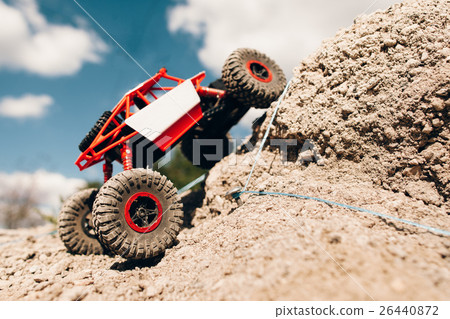 Suv overcoming rock rise, close-up. 26440872