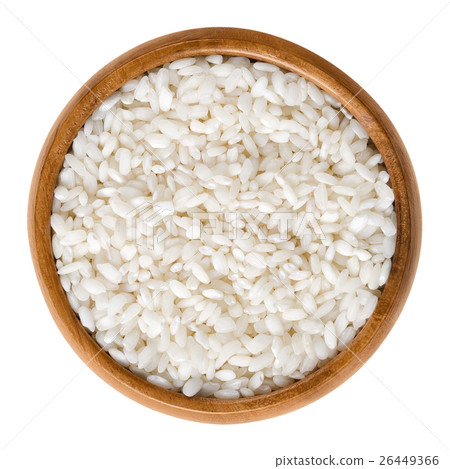 Arborio risotto rice in wooden bowl over white 26449366