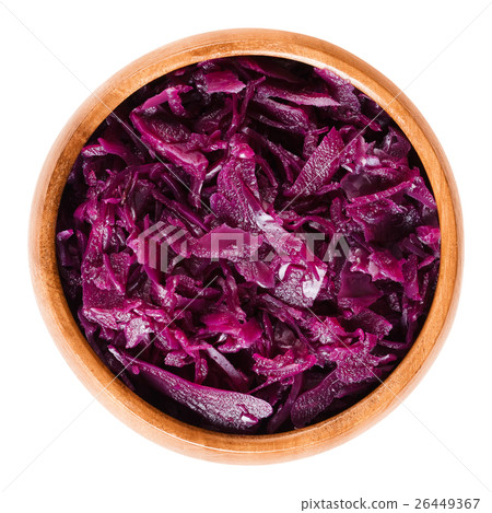 Cooked red cabbage in wooden bowl over white 26449367