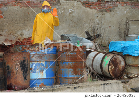 Man with protective mask explores danger area. 26450055