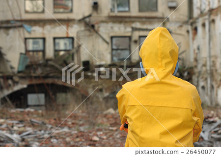 Man with protective mask explores danger area. 26450077