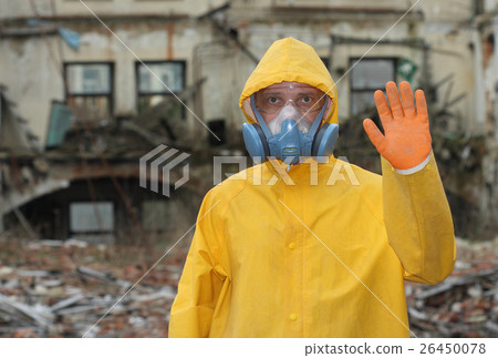 Man with protective mask explores danger area. 26450078