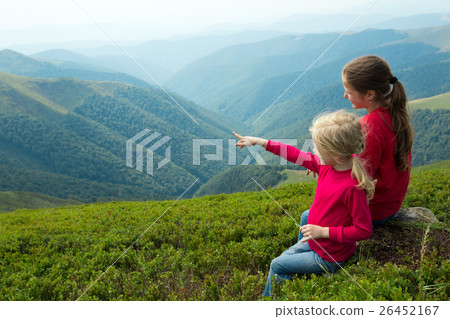 two girls looking at the mountains two girls looking at the mountains 26452167