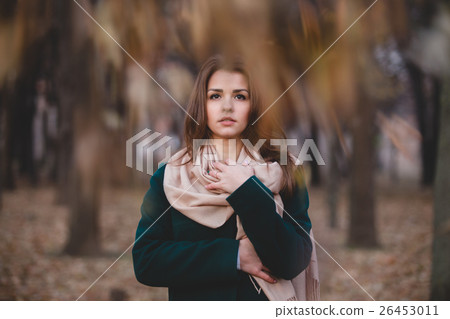 Autumn outdoor portrait of young beautiful 26453011
