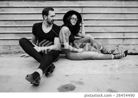 man and woman posing on a background gray wall 26454490