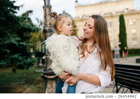 Mother and little daughter in a park Mother and little daughter in a park 26454942