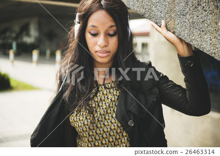 African Woman Listening Music Media Entertainment Relaxation Concept African Woman Listening Music Media Entertainment Relaxation Concept 26463314