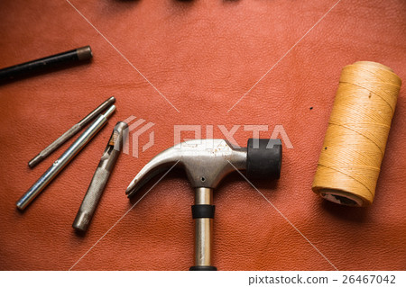 Leather crafting tools on work table. 26467042