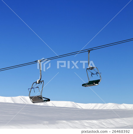 Chair-lift and blue clear sky at sun day 26468392