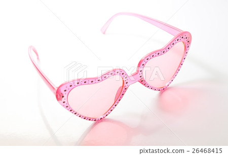 Pink heart shaped sunglasses on white background Pink heart shaped sunglasses on white background 26468415