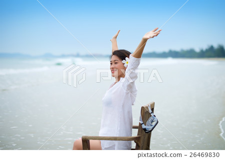 Girl with arms wide open on chair at beach Girl with arms wide open on chair at beach 26469830