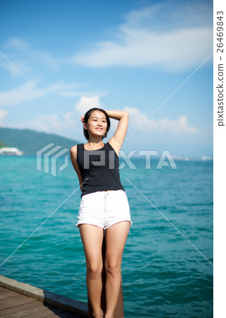 Asian girl at a beach pier Asian girl at a beach pier 26469843
