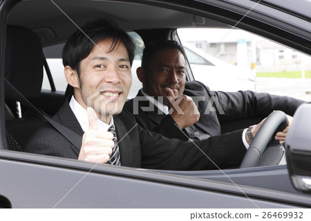 Two salaried workers riding a car Two salaried workers riding a car 26469932