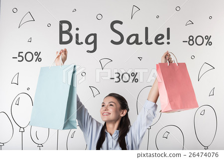 Cheerful woman feeling happy with big sales in 26474076
