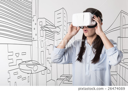 Young woman using visual reality device 26474089