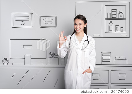 Pretty doctor making an okay gesture 26474090