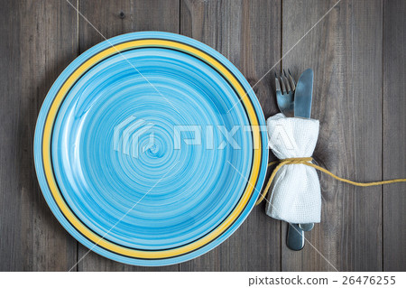 empty blue round plate with fork and knife wrapped empty blue round plate with fork and knife wrapped 26476255
