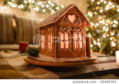 Homemade gingerbread house on background room Homemade gingerbread house on background room 26480263