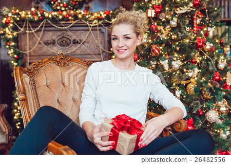 Young pretty blonde woman sitting on chair near Young pretty blonde woman sitting on chair near 26482556