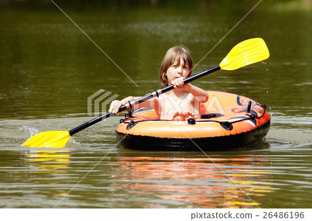 Boy with Blond Hair Paddles Inflatable Rubber Boat 26486196
