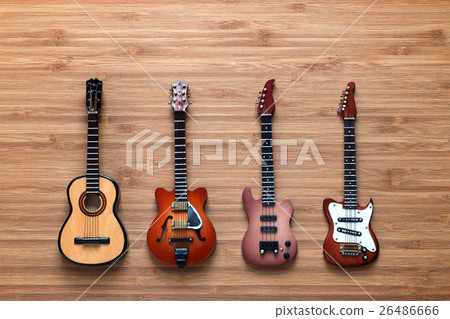 Set of four guitars on a wooden background. Set of four guitars on a wooden background. 26486666