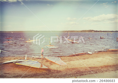Windsurfers are preparing to compete at the lake Windsurfers are preparing to compete at the lake 26486683