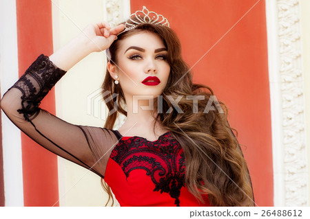 Beautiful young girl in a red evening long dress 26488612