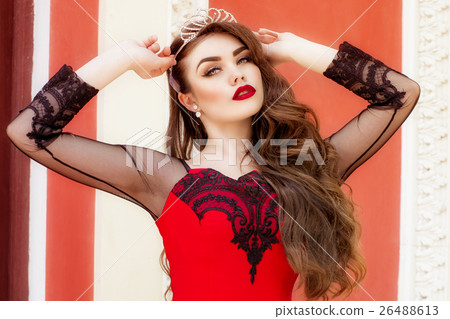 Beautiful young girl in a red evening long dress 26488613