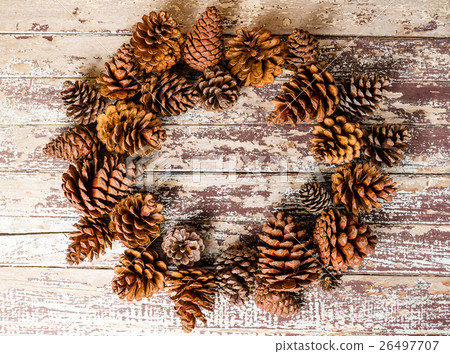 Top view of pine cones on rustic wooden background 26497707