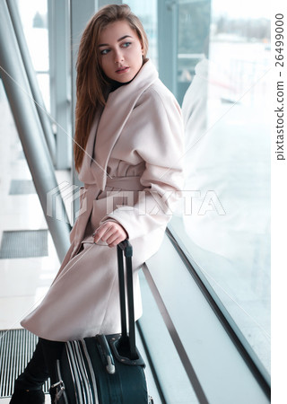Passenger woman in airport waiting for air travel. Passenger woman in airport waiting for air travel. 26499000