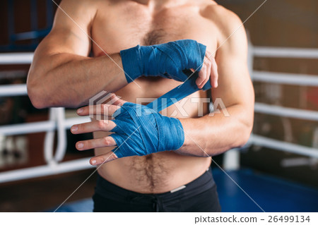 Boxer pulls bandage before the fight or training. 26499134