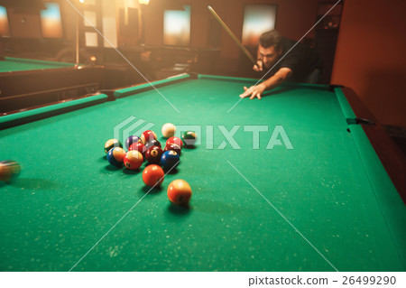 Player breaks a pyramid in billiards. Player breaks a pyramid in billiards. 26499290