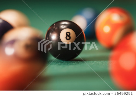 Pool ball with number 8 over green background. 26499291