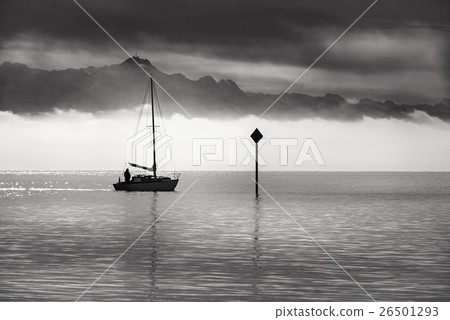 Monochrome image of a single boat sailing 26501293