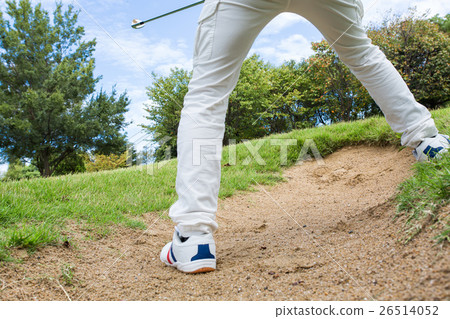A man who plays a bunker shot at a golf course A man who plays a bunker shot at a golf course 26514052