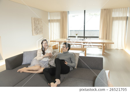 Male and female relaxing in the living room Male and female relaxing in the living room 26521705