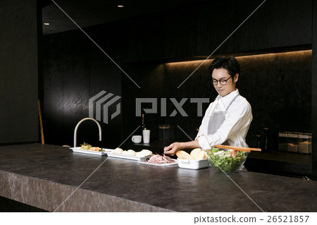 A man standing at a counter A man standing at a counter 26521857