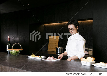 A man standing at a counter 26521858