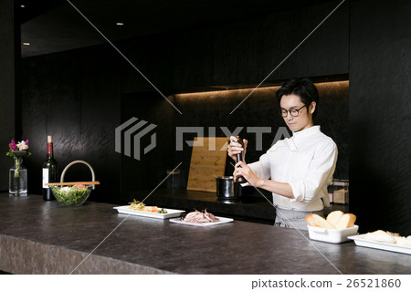 A man standing at a counter A man standing at a counter 26521860