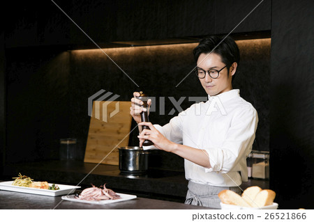 A man standing at a counter A man standing at a counter 26521866