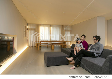 A family relaxing in the living room A family relaxing in the living room 26521868