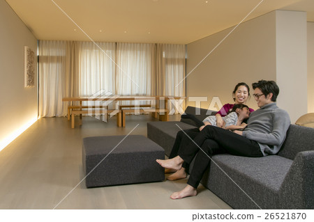 A family relaxing in the living room A family relaxing in the living room 26521870