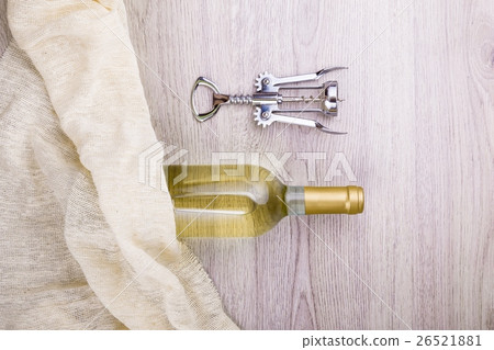 Wine bottle with corkscrew on wooden background 26521881