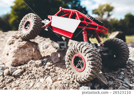 Toy crawler overcoming rock close-up 26523110