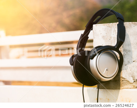 Headphone with sunlight on stall wood. 26524627