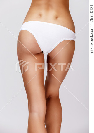 Slim tanned woman's body over gray background 26528121